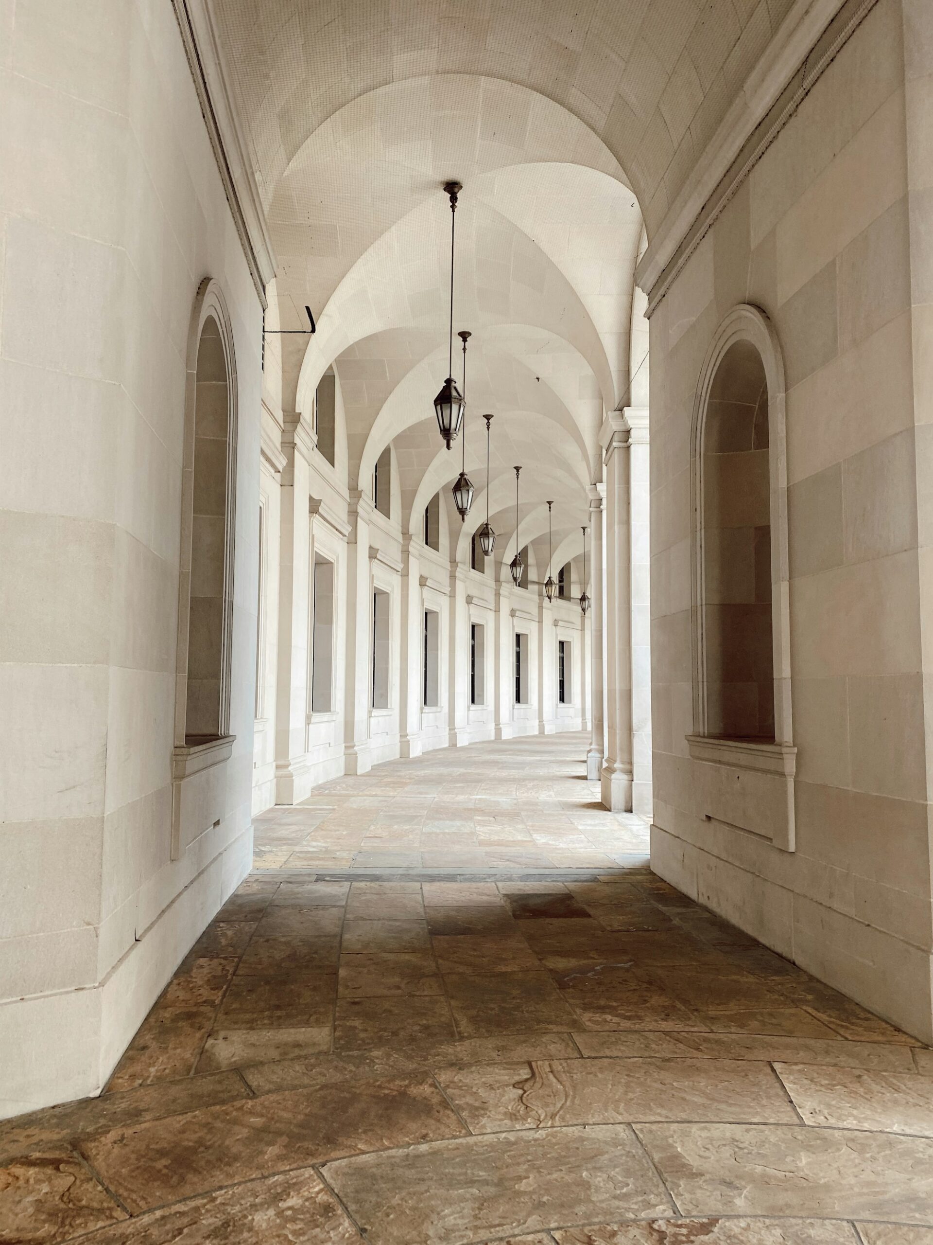 A quiet stone colonnade in warm natural light