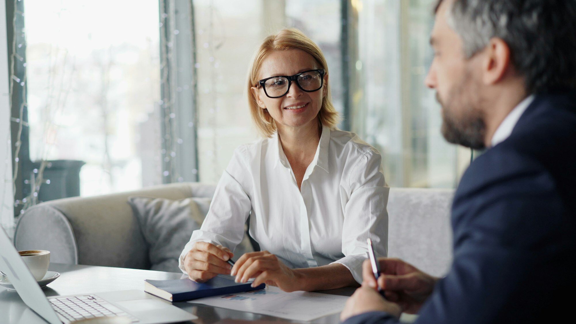 An attorney listening to a client during a consultation