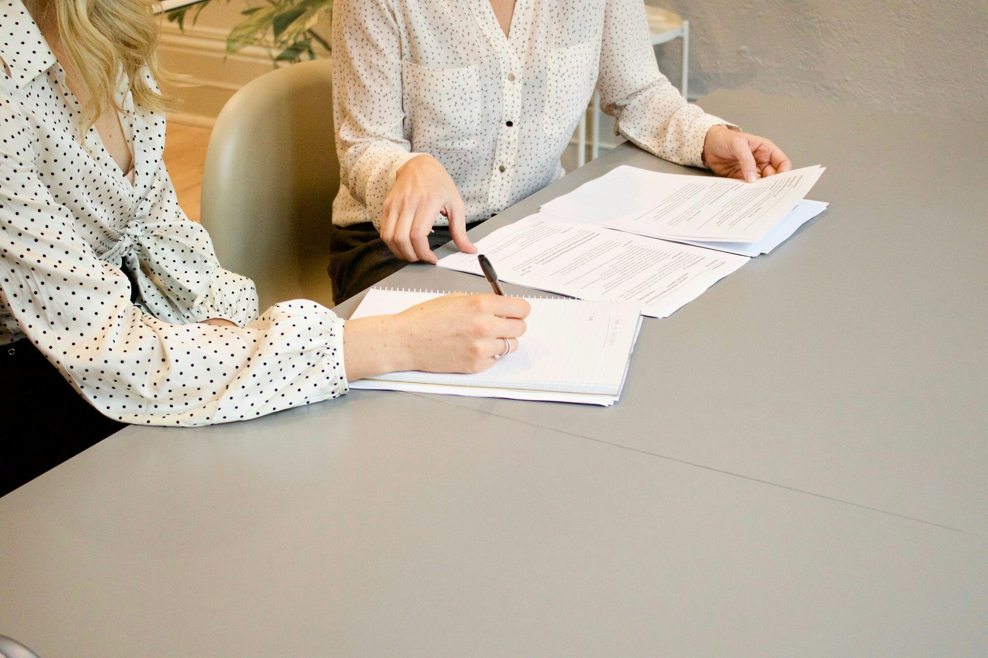A client reviewing and signing documents at a table